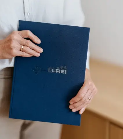 Investor holding an LREI investment performance folder
